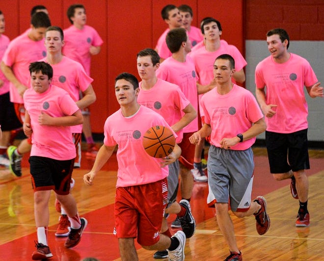 Morton high school basketball players run with a basketball in the school's west gymnasium on Thursday for the Children's Hospital of Illinois Gameball Run benefit.