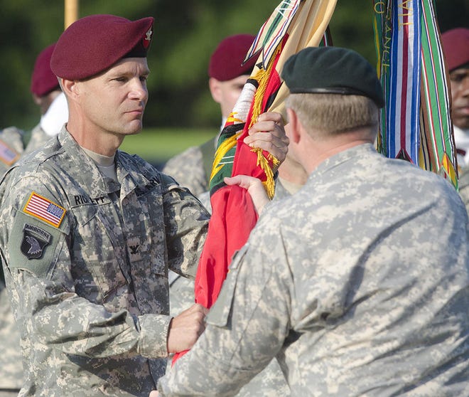 Lt. Gen. Charles T. Cleveland, U.S. Army Special Operations Command Commanding General, passes the unit colors to Col. Daniel Rickleff, symbolizing the transfer of authority, during the 528th Sustainment Brigade’s (Special Operations) (Airborne) Change of Command ceremony in July 2013. Rickleff took command from Col. Thomas Rogers.