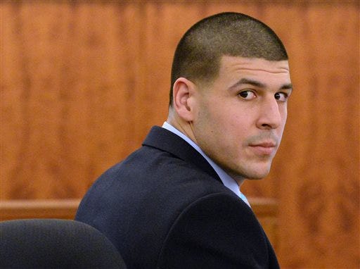 Former New England Patriots football player Aaron Hernandez looks back during his murder trial at Bristol County Superior Court, Thursday, Feb. 5, 2015, in Fall River, Mass. Hernandez is accused of the June 2013 killing of Odin Lloyd. (AP Photo/Faith Ninivaggi, Pool)