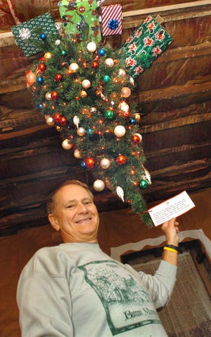 Friends of Bolton Mansion President, Jim Snow, displays the upside down Christmas tree and it's historical significance.............Gentile 11/29/06