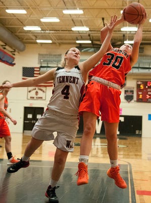 Pennsbury's Meredith Webber (right) grabs a rebound as Tennent's Alyssa Christiansen reaches in during a girls basketball game in Warminster the evening of Friday, February 6, 2015.