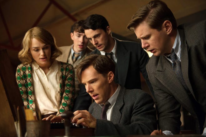 In this image released by The Weinstein Company, Keira Knightley, from left, Matthew Beard, Matthew Goode, Benedict Cumberbatch, seated, and Allen Leech appear in a scene from "The Imitation Game." (The Weinstein Company, Jack English)