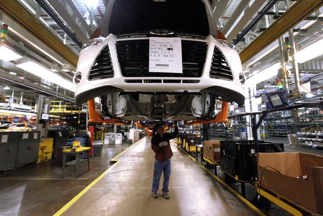 In this Dec. 14, 2011, file photo, a line worker assembles a 2012 Ford Focus at the Ford Michigan Assembly plant in Wayne, Mich. The jobs report on Friday signaled that raises have finally begun to flow through an economy in which, once you factor in inflation, most people earn less than when the Great Recession struck in 2007. Ford has announced that up to 500 of its lowest-paid factory workers will receive a 48 percent pay raise to $28.50 an hour. Other major companies, including Aetna and the Gap, have also announced pay increases.