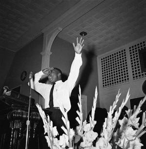 Integration leader Martin Luther King Jr., Atlanta minister, speaking to a church filled to overflowing, in Albany, Georgia on July 22, 1962, about the legal fights ahead. King and other integration leaders and organizations fighting to break down segregation will start court action in a effort to upset a Federal injunction issued on banning protest demonstrations. (AP Photo)
