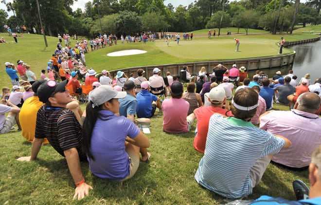 Spectators watch the leaders from the hill overlooking the green on hole #4 during final round action in the final round of The Players Championship Sunday, May 11 at the TPC Sawgrass Players Stadium Course.