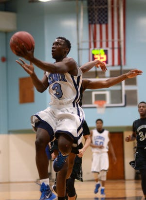 Lenoir Community College's Davon Edwards (3) drives for a layup in Saturday's home game against Richard Bland College.