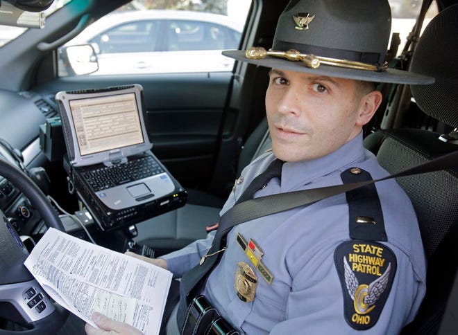 Ohio State Highway Patrol Lt. Antonio Matos demonstrates the electronic citation system inside a patrol car at the Cleveland Metro Post in Brook Park, on Jan. 28. The patrol switched to the e-ticketing process to reduce errors, save time and make the paperwork easier to read and want to take it a step further by arranging for citations to be electronically transmitted to local courts instead of being hand-delivered on paper.