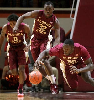 Michael Ojo (50) of Florida St. falls on a loose ball as teammates Phil Cofer (0) and Montay Brandon (32) watch during the first half an NCAA basketball game against Virginia Tech in Blacksburg, Va., Saturday Feb. 7 2015.(AP Photo/The Roanoke Times, Matt Gentry) LOCAL TELEVISION OUT; SALEM TIMES REGISTER OUT; FINCASTLE HERALD OUT; CHRISTIANBURG NEWS MESSENGER OUT; RADFORD NEWS JOURNAL OUT; ROANOKE STAR SENTINEL OUT