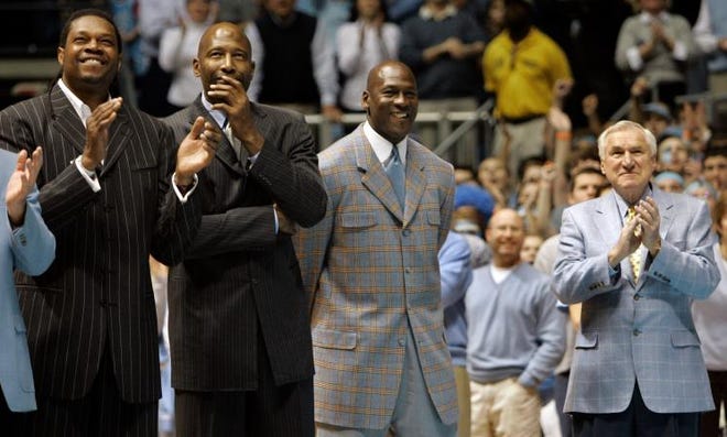Former North Carolina players, from left, Sam Perkins, James Worthy, Michael Jordan and former coach Dean Smith are recognized during halftime of a college basketball game against Wake Forest in Chapel Hill on Feb. 10, 2007. Dean Smith died at age 83 on Sunday.
