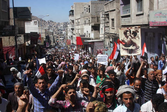 Yemenis hold a rally to protest against Houthi Shiite rebels, who took over the government of Yemen and installed a new committee to govern, in Taiz, Yemen, Saturday, Feb. 7, 2015. The six Arab countries of the Gulf Cooperation Council denounced the Shiite rebel takeover of Yemen as a "coup" Saturday, calling for the United Nations to take action as thousands demonstrated in the streets against their power grab. Photo at right shows former presidents, Ibrahim al-Hamdi, right, and Salim Rubai Ali. (AP Photo/Hani Mohammed)
