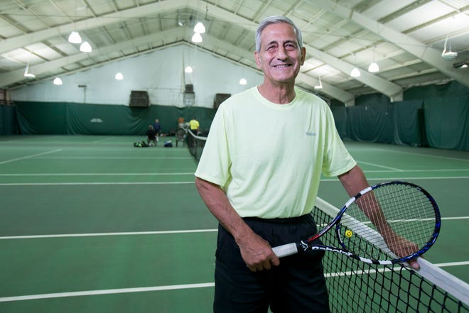 Ron Balsam stands at the net Tuesday, Sept. 30, 2014, at the Forest City Tennis Center in Rockford. Balsam plays at least three times a week with a group the competes in the USTA senior league. MAX GERSH/RRSTAR.COM