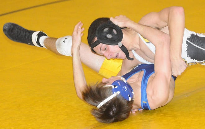Bordentown's Billy Moore throws Maple Shade's Cullen McClintock on his back at the 106lb match at Bordentown High School on Monday Feb 9, 2015.