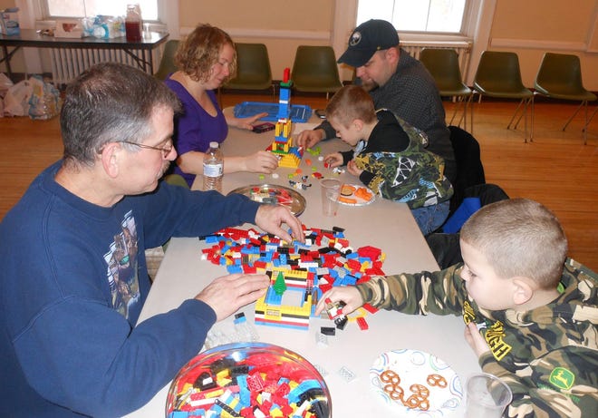 Participants in the Lego Build-Off at the Ilion Municipal Building on Sunday work on their creations at the Ilion Municipal Building. Pictured in front from left is Ron Hocking, and grandson Tyler Hocking. Pictured in the back from left is Amy Hanna, of Ilion, Thomas Roepnack and Riley Hanna. Telegram photo/Stephanie Sorrell-White
