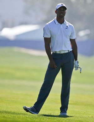 Tiger Woods appears frustrated after his short approach shot missed the green on the 10th hole of the north course at Torrey Pines during the first round of the Farmer Insurance Open golf tournament Thursday, Feb. 5, 2015, in San Diego. Woods later withdrew from the tournament with back problems.