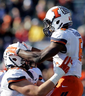 Illinois running back Josh Ferguson (6) celebrates with offensive line Christian iLauro (67) after scoring a touchdown against Northwestern during the first half of an NCAA college football game on Saturday, Nov. 29, 2014, in Evanston. The teams will play at Soldier Field in Chicago, home of the Chicago Bears, in 2015, 2017 and 2019.