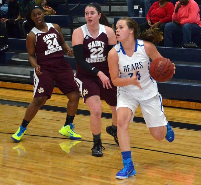 PETER.WILLOTT@STAUGUSTINE.COM Bartram Trail High School's Brooke Barlow dribbles the ball around St. Augustine High School's Eboni Daniels and Courtney Cox in the third quarter of their game on Tuesday, January 6, 2015 at Bratram.