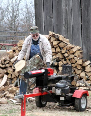 Jamie Mitchell - Times Record - Charles Daniels wrestles a lage log onto his gas powered splitter, Wednesday, Feb 04, 2015, in front of his barn on Puddin Ridge. Daniels said he's lived all of his life along the ridge south of Rye Hill, alson known a Tennessee Ridge in south Fort Smith. 
 Jamie Mitchell - Times Record - Charles Daniels wrestles a lage log onto his gas powered splitter, Wednesday, Feb 04, 2015, in front of his barn on Puddin Ridge. Daniels has lived all of his life along the ridge south of Rye Hill, alson known a Tennessee Ridge in south Fort Smith.