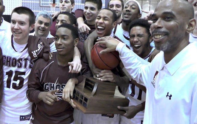 Abington boys basketball head coach, Charles Grasty (right) smiles along with his team while holding the Suburban One League boys basketball championship trophy Tuesday February 10, 2015 after defeating Pennsbury 63-50 at Souderton Area High School in Franconia.