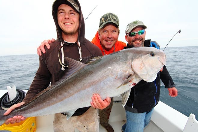 Adam Schroder and his dad Oz, deckhand on the Sea Winder, along with Capt. Couvillion show off one of the many amberjack they pulled in on a recent outing.