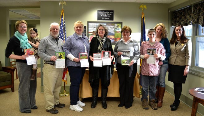 REGION - Numerous area photographers, professional and amateur, took part in Senator Lisa Baker’s photography contest, “Scenes from the 20th Senatorial District” where scenes from the district were submitted and chosen by the public, ultimately securing a month on a 2015 calendar. Last week, a few of the winners received a certificate and calendar from Baker at her Lake Wallenpaupack office. Winners include, from left include Jeanette Niebauer, Dallas Township; Jeffrey Sidle, Hawley; Kim Erickson, Cherry Ridge Township; Eileen Chorba, Beach Lake; Katie Larsen-Lick, Fairview Township; and Cindy Innella, Shohola. At right is Senator Baker. News Eagle photo by Katie Collins