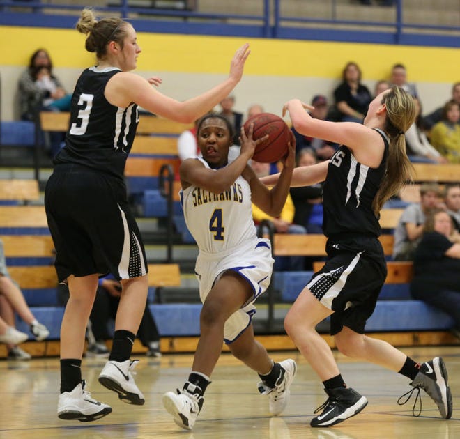 Hutchinson's Lyric Martin splits Campus defenders Hayley Leeper and Gabby Bosley in the third quarter Tuesday, Feb. 10, 2015 at the Salthawk Activity Center.