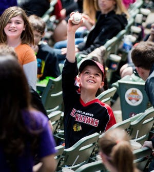 Turner Grishaw, 11, of East Peoria shows off the foul ball he caught during a Dare Day matinee at the Peoria Chiefs.