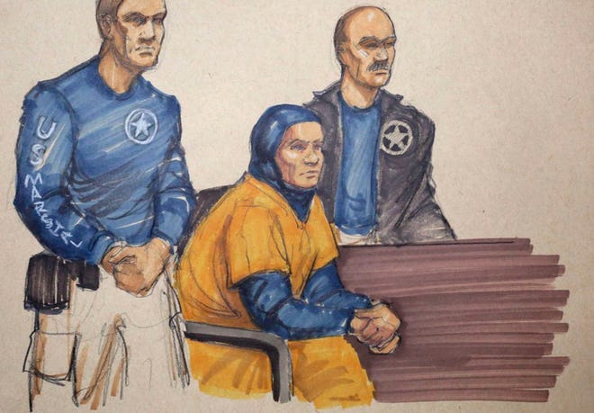 In this Monday, Feb. 9, 2015 courtroom sketch, Mediha Medy Salkicevic, center, appears in federal court in Chicago. Salkiceveic is accused with five other Bosnian immigrants of sending money and equipment to extremist groups in Syria. Salkiceveic appeared before Judge Jeffrey Cole who put off a decision until Tuesday about whether to allow Salkicevic out of jail to travel to St. Louis, where the case originated, rather than remain in custody and be transported by U.S. Marshals. (AP Photo/Tom Gianni)