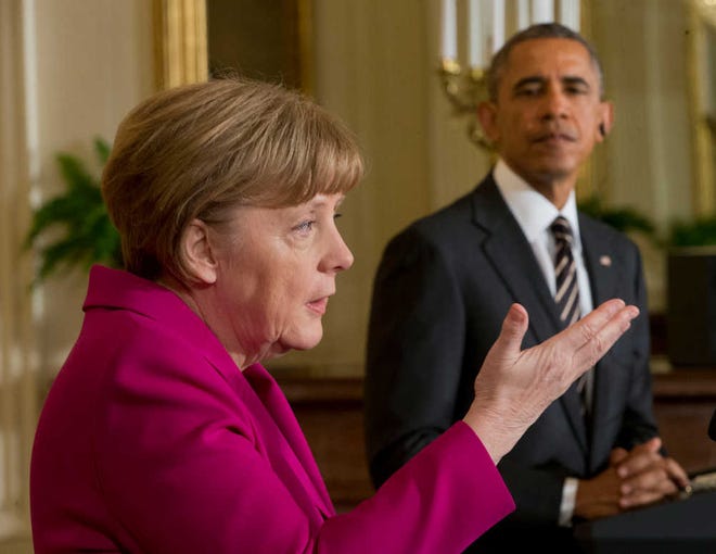 President Barack Obama listens as German Chancellor Angela Merkel speaks during their joint news conference in the East Room of the White House in Washington, Monday, Feb. 9, 2015. The leaders were expected to discuss the ongoing conflict in Ukraine, and arming Ukrainian fighters to wage a more effective battle against Russian-backed separatists. (AP Photo/Pablo Martinez Monsivais)