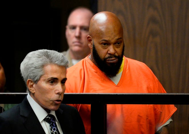 In this Feb. 3 file photo, Marion "Suge" Knight, right, is joined by attorney David Kenner during his arraignment, in Compton, Calif.