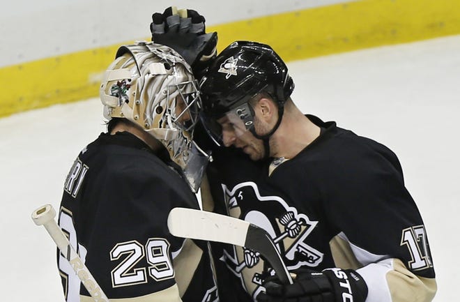 The Penguins' Blake Comeau, right, greets goalie Marc-Andre Fleury after defeating the Red Wings in Wednesday's game in Pittsburgh.