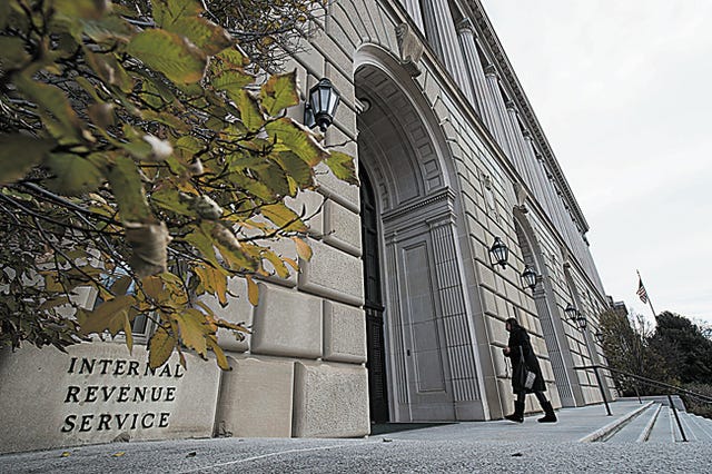 Workers enter the IRS building on Dec. 11, 2014 in Washington, D.C. A 1978 provision, known as the safe harbor, provides blanket protection to tens of thousands of business to identify their workers as independent contractors for tax purposes even though the worker is, in fact, an employee. Experts say the safe harbor is one of the greatest barriers to IRS collecting taxes on companies who misclassify their workers. (Molly Riley/McClatchyDC/TNS)