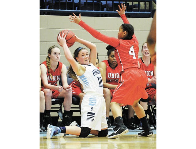 Bartlesville High School senior Erin Henry, left, goes to her knees but looks to make a pass around Tulsa Union High School defender Micah Patrick, during Tuesday’s varsity girls basketball thriller at the Bruin Fieldhouse. The Bartlesville Lady Bruins won in double-overtime, 45-38, to sweep the season series against Tulsa Union. Bartlesville squandered a 17-point lead, as Tulsa Union came back to tie the game, 33-33, and send it to overtime. The Bruins regrouped in the second overtime. Becky Burch/Examiner-Enterprise 
 Bartlesville High School senior forward Hailey Tucker, second from left, struggles against gritty Tulsa Union’s gritty defense during an intense varsity girls basketball game Tuesday night at the Bruin Fieldhouse. Bartlesville won in double-overtime, 45-38. Becky Burch/Examiner-Enterprise