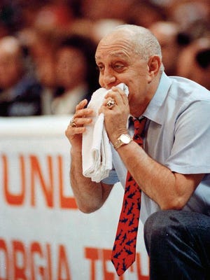 In this April 2, 1990, file photo, UNLV coach Jerry Tarkanian chews on his towel while watching his team play Duke in the championship game of the NCAA college basketball Final Four in Denver. Hall of Fame coach Jerry Tarkanian, who built a basketball dynasty at UNLV but was defined more by his decades-long battle with the NCAA, died Wednesday, Feb. 11, 2015, in Las Vegas after several years of health issues. He was 84.