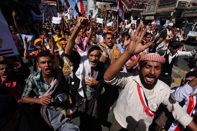 Yemeni protesters shout slogans against Houthi Shiites who have seized power in the capital, Sanaa, as they celebrate the fourth anniversary of the uprising in Taiz, Yemen, Wednesday, Feb. 11, 2015. The United States, Britain and France moved to close their embassies in Yemen on Wednesday, increasing the isolation of Shiite rebels who have seized power. (AP Photo/Anees Mahyoub)