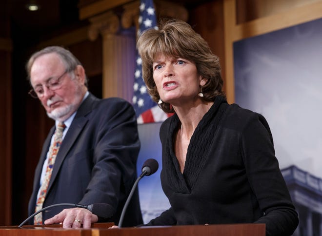 ''This administration has effectively declared war on Alaska,'' U.S. Sen. Lisa Murkowski, R-Alaska, chairwoman of the Senate Energy and Natural Resources Committee said Wednesday. She and Rep. Don Young, R-Alaska, are shown above at a news conference last month about Alaska's energy future. Below, adult female walruses are on an ice flow with young walruses in July 2012 in the eastern Chukchi Sea.