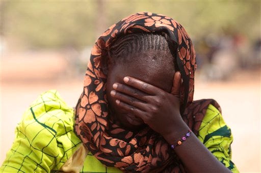 In this photo taken Saturday, Jan. 31, 2015. Dorcas Aiden, 20 years old , speaks to a journalist in Yola, Nigeria. Dorcas Aiden was another of the girls caught in Boko Haramâ€™s siege. She had finished high school and was living at home when the war came to her village. Fighters took her to a house in the town of Gulak and held her captive for two weeks last September. The more than 50 teenage girls crammed into the house were beaten if they refused to study Quranic verses or conduct daily Muslim prayers, she says. When the fighters got angry, they shot their guns in the air. Aiden finally gave in and denied her Christian faith to become Muslim, at least in name, she says. (AP Photo/Lekan Oyekanmi)