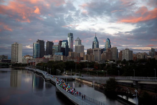 In this Oct. 1, 2014 file photo, runners jog along the Schuylkill Banks Boardwalk in Philadelphia. Democrats have selected Philadelphia as the site of the party's 2016 national convention, choosing a patriotic backdrop for the nomination of its next presidential candidate. The Democratic National Committee said Thursday, Feb. 12, 2015 the convention will be held the week of July 25, 2016. The two other finalists were Brooklyn, New York, and Columbus, Ohio. (AP Photo/Matt Slocum)