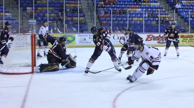 Rivermen goaltender Kyle Rank and center Alex Hudson (23) hold off a scoring threat from Fayetteville's Mike Montrose during Peoria's 2-1 loss in OT at Crown Coliseum on Dec. 5, 2014.