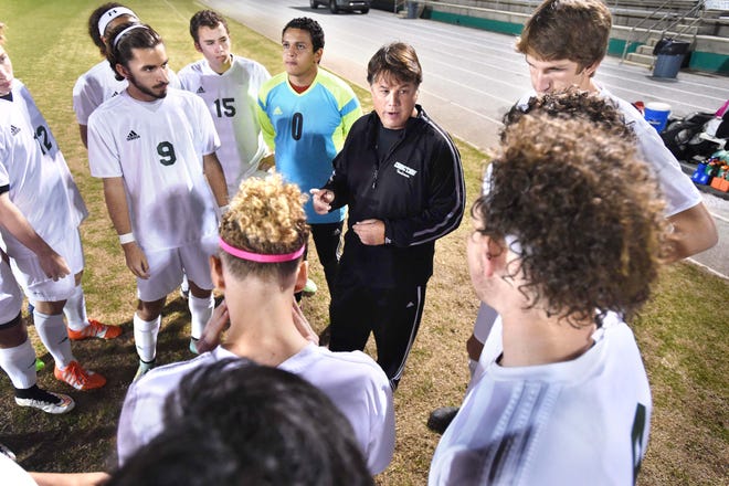 Choctaw boys soccer coach Chris McDaniel and his players huddle together before a game earlier this year.