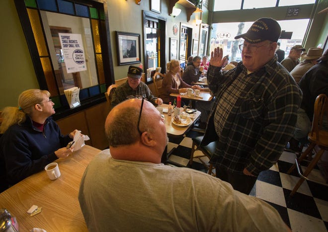 Veteran Bill Daily (right) chats with fellow veteran Jeff Rosemeyer of Roseburg as they bond over shared stories and breakfast at Buster’s Main Street Cafe in Cottage Grove on Wednesday. Owner Paul Tocco has been providing veterans and active-duty servicemen and women free meals on the 11th of every month since November 2013. It’s now 16 “Veterans Days” and counting. (Brian Davies/The Register-Guard)