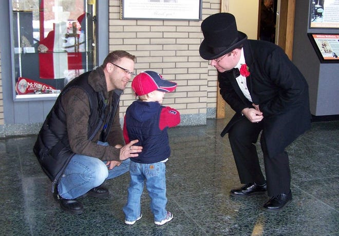 A young visitor to the McKinley Presidential Library and Museum says “Hello” to President William McKinley, portrayed by Christopher Kenney, director of education at the museum.