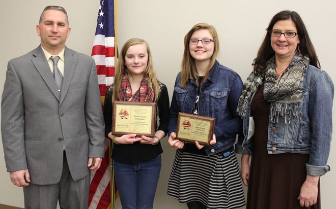 Stark County Junior High sixth grader Olivia Bessler, second from left, is the county spelling bee champion. Stark County eighth grader Alayna Steward was the runner-up. Bureau, Henry, and Stark County Regional Assistant Supt. Brad Hulick, left, presented the trophies. Teacher Angela Tuttle, right, is the Stark County School District's spelling bee coordinator.