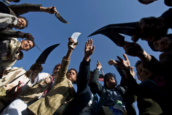 Supporters of Houthi Shiites wave traditional daggers and dance as they celebrate the fourth anniversary of the uprising in Sanaa. The Houthis are threatened by the advance of al-Qaida.
