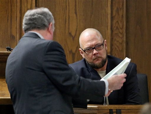 Court appointed defense attorney Tim Moore, left, shows James Watson, uncle to ex-Marine Eddie Ray Routh, photographs that are evidence from Routh's house during testimony in Routh's capital murder trial at the Erath County, Donald R. Jones Justice Center in Stephenville, Texas, Friday, Feb. 13, 2015. Routh, 27, of Lancaster, is charged with the 2013 deaths of former Navy SEAL Chris Kyle and his friend Chad Littlefield at a shooting range near Glen Rose, Texas. Watson testified that he smoked marijuana with Routh on the day of the killings.