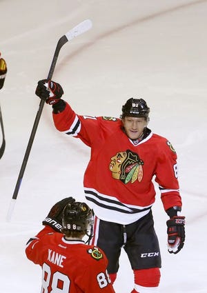 Chicago Blackhawks right wing Marian Hossa celebrates his goal with Patrick Kane during the third period of an NHL hockey game against the New Jersey Devils on Friday, Feb. 13, 2015, in Chicago. The Blackhawks won 3-1.