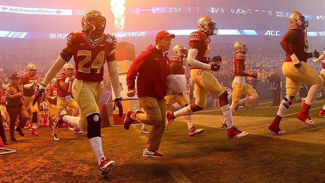 Head coach Jimbo Fisher and his Florida State Seminoles take the field against the Georgia Tech Yellow Jackets for the ACC Championship game on December 6, 2014 in Charlotte, North Carolina. (Photo by Mike Ehrmann/Getty Images)
