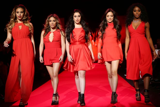 In this Thursday, Feb. 12, 2015 photo released by Starpix, members of Fifth Harmony, from left, Dinah Jane Hansen, Ally Brooke, Lauren Jauregui, Camila Cabello and Normani Hamilton walk the runway at the Go Red for Women Red Dress Fashion Show at Lincoln Center in New York. (AP Photo/Starpix, Kristina Bumphrey)