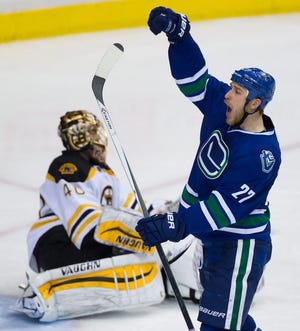 Vancouver’s Shawn Matthias (right) celebrates his third goal of the night against Bruins goalie Tuukka Rask during the third period of Friday’s Canucks win.