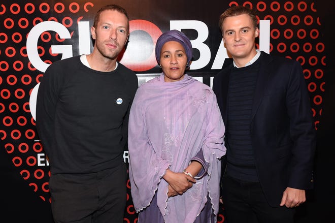 Coldplay frontman Chris Martin, left, UN Secretary-General's Special Adviser on Post-2015 Development Planning, Amina J Mohammed, center, and CEO of The Global Poverty Project Hugh Evans, pose together at the Global Citizen 2015 media luncheon at Locanda Verde on Friday, Feb. 13, 2015, in New York. (Scott Roth/Invision/AP)