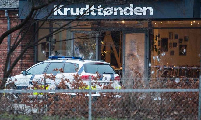 The scene outside the Copenhagen cafe, with bullet marked window, where a gunman opened fire Saturday, Feb. 14, 2015, in what is seen as a likely terror attack against a free speech event organized by an artist who had caricatured the Prophet Muhammad. The police believe there was only one shooter in the attack on a Copenhagen cafe that left one person dead and three police officers wounded during a free speech event. (AP Photo/Polfoto, Janus Engel) DENMARK OUT